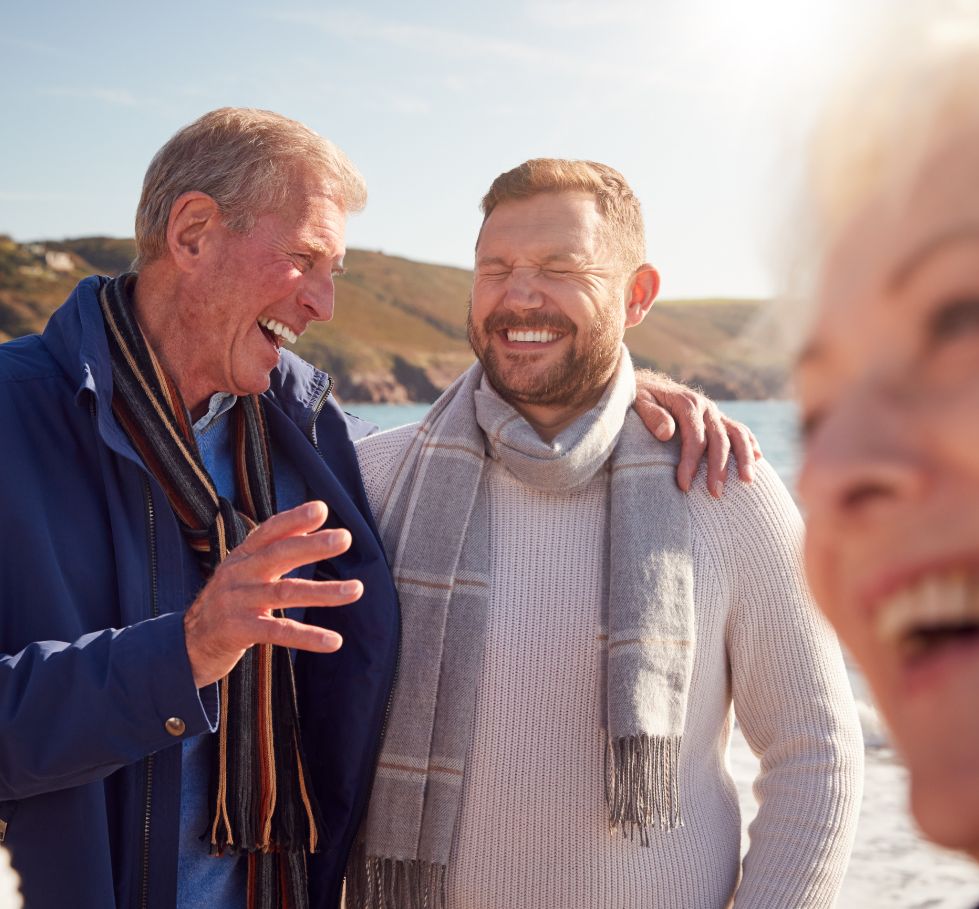 Two people talking on a beach